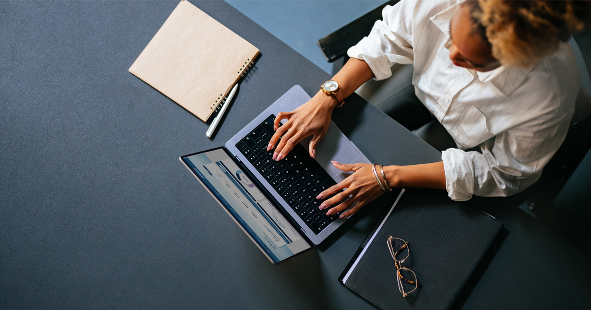 Arial view of person typing on a laptop.